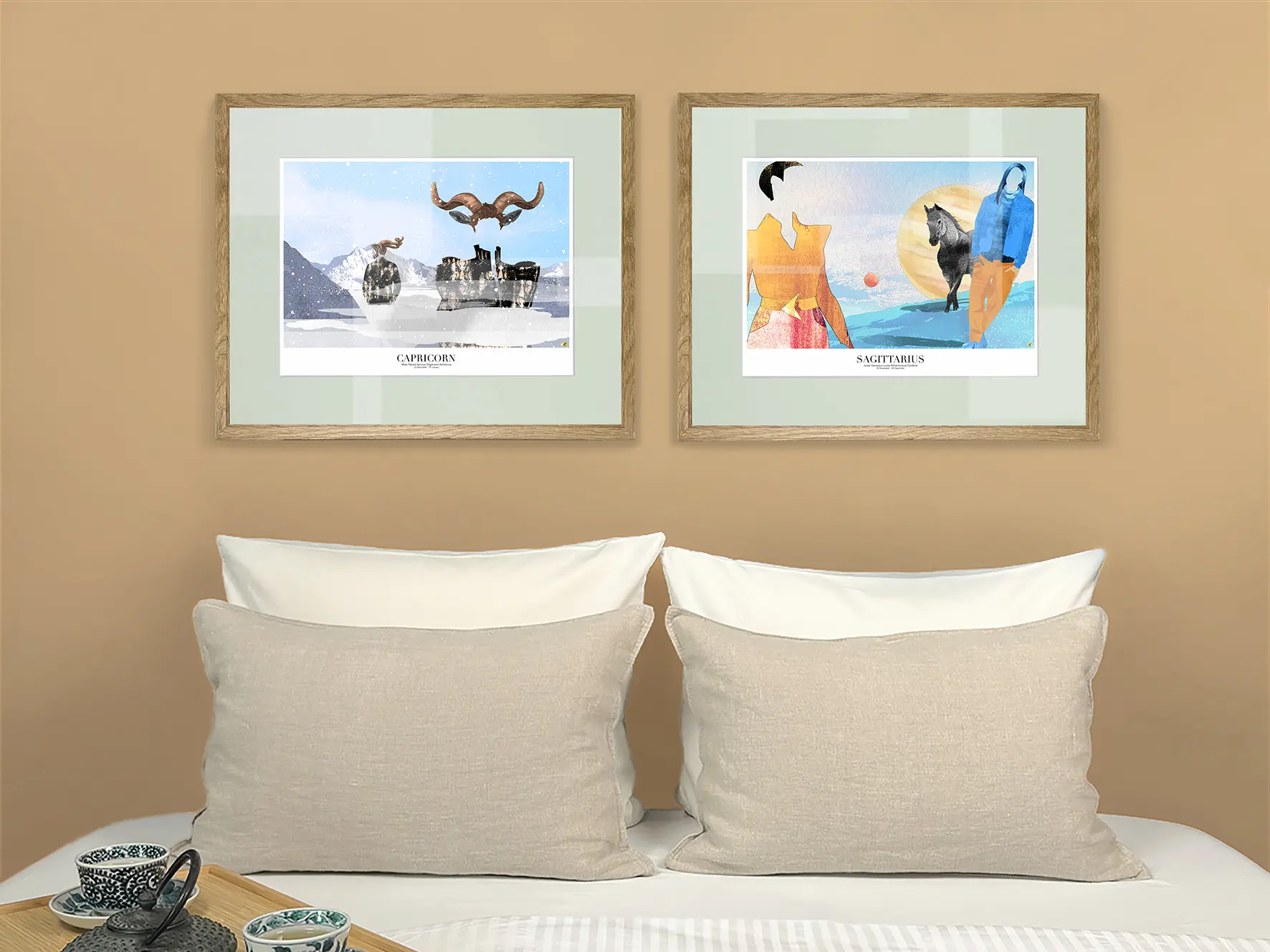 Two framed artwork pieces which represent the zodiac signs Capricorn and Sagittarius. The pictures are hung above a bed with white sheets and white and light beige pillows.